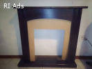 wooden fireplace mantel surround with a